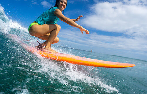 woman surfing on a beautiful sunny day